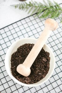 Mortar and pestle crunching up oreo cookies.