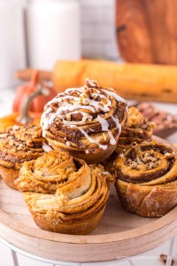 Pile of pumpkin cinnamon roll muffins.