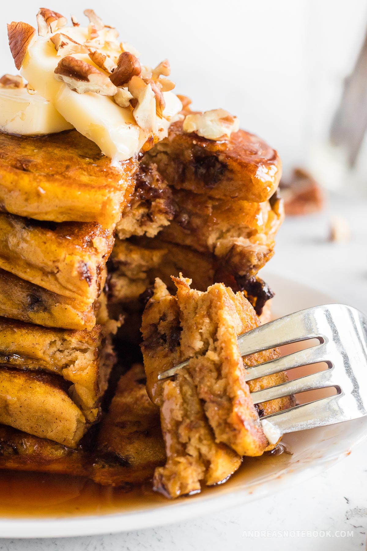 Fork cutting slice out of pumpkin pancake stack.