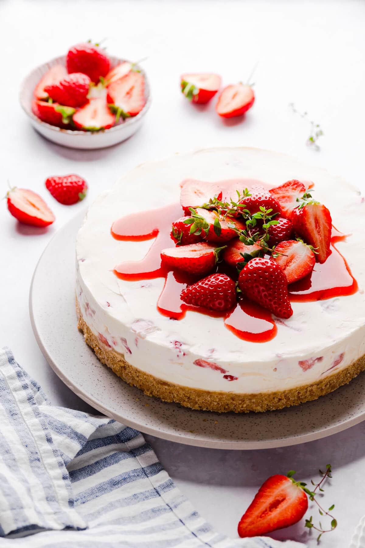 Beautiful strawberry white chocolate cheesecake with piled strawberries on top.
