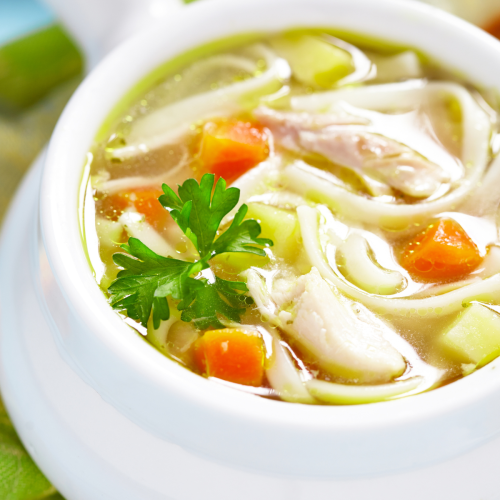 Crockpot chicken noodle soup in a white bowl.