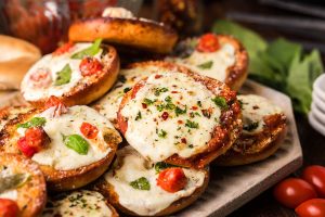 Homemade pizza bagels on a plate.
