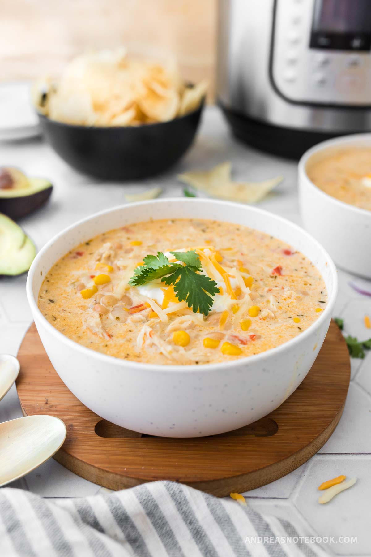 Bowl of white chicken chili with an Instant Pot in the background.