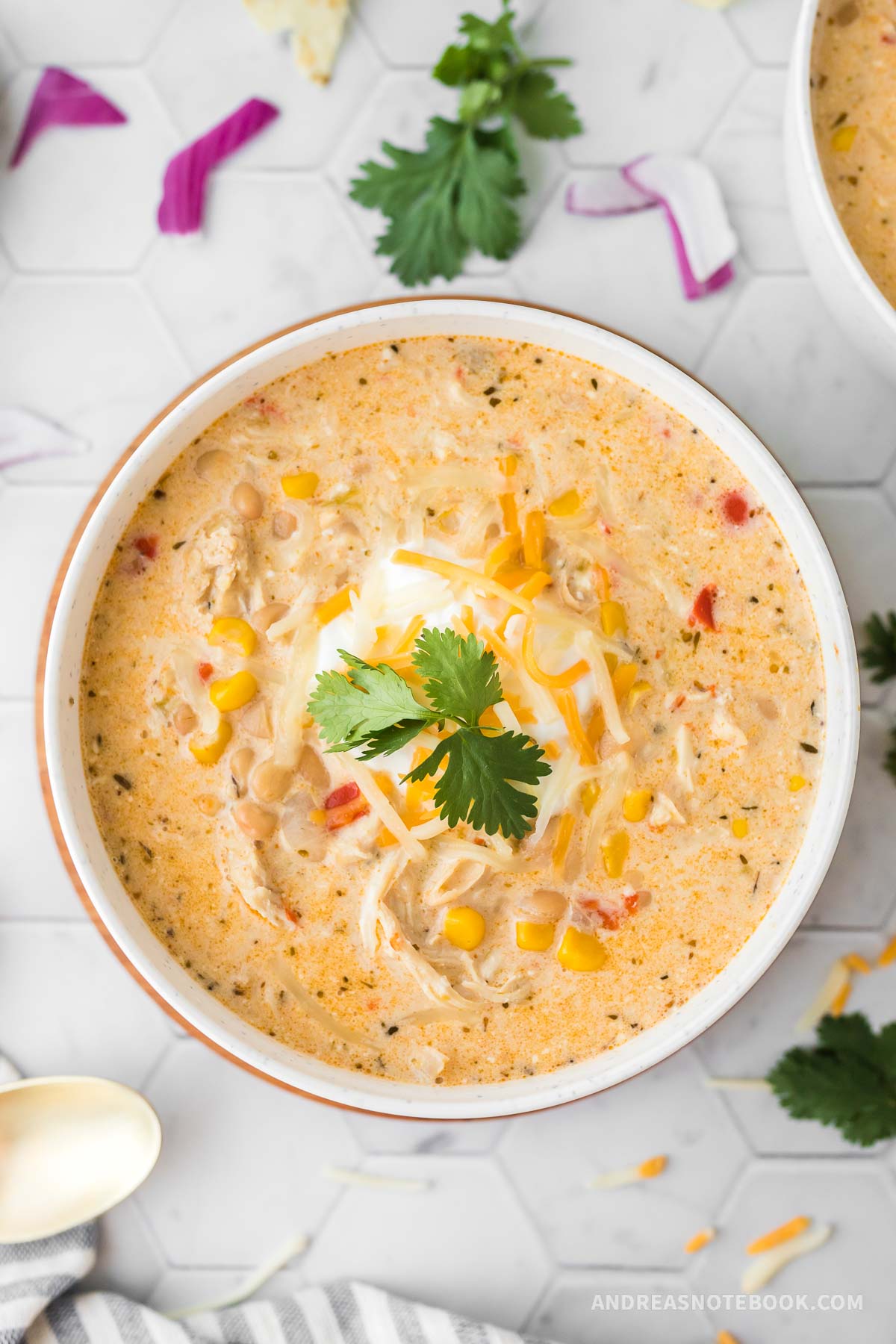 Instant pot chicken chili in a bowl topped with sour cream and cilantro.