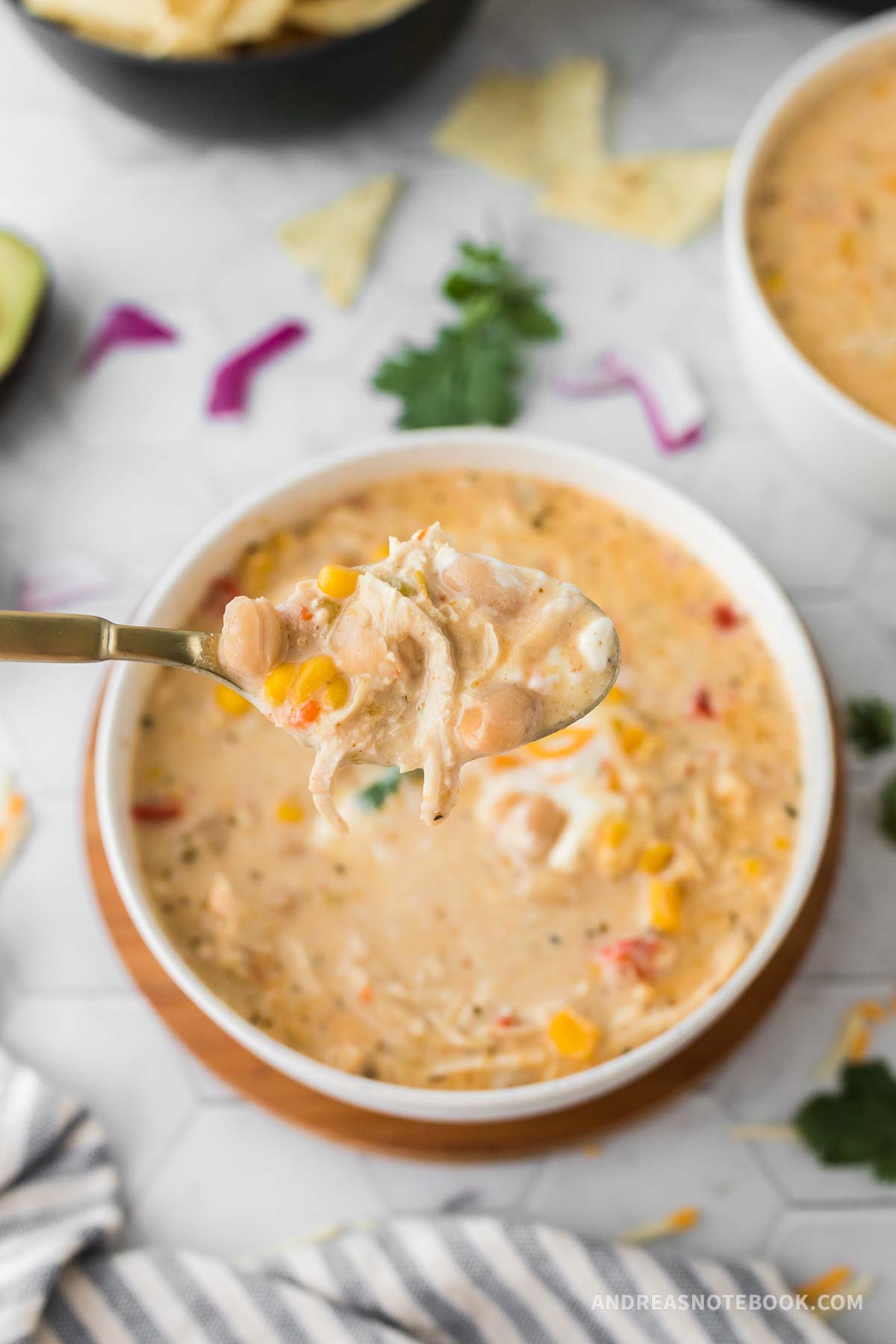 Spoon scooping up Instant Pot white chicken chili.