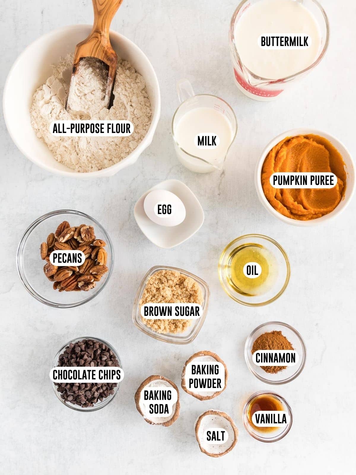 Pumpkin spice pancakes ingredients in bowls.