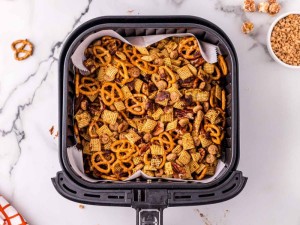 Chex mix in the air fryer basket.