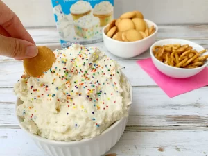 Funfetti cake dip recipe with cookie dipping in it.