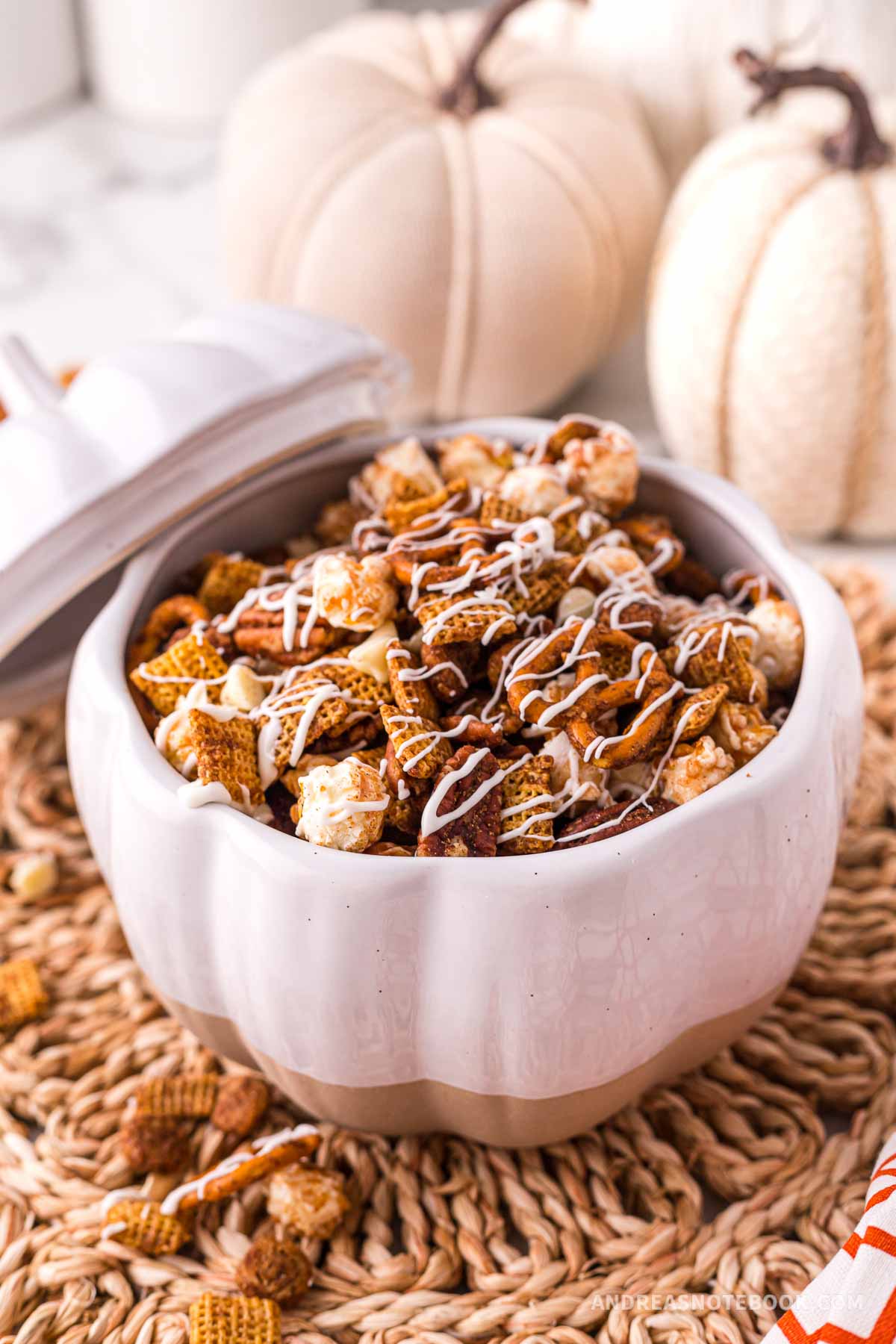 christmas chex mix recipe in a pumpkin shaped bowl.