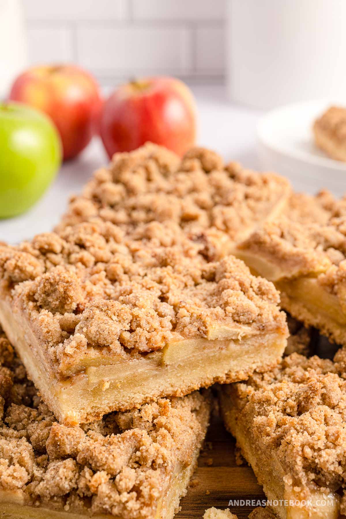 Stacked apple pie bars with streusel topping.