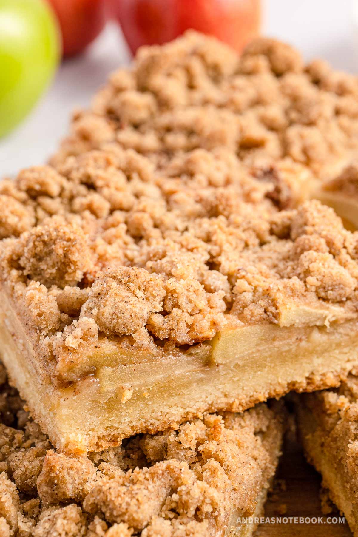 Stack of apple pie bars with streusel topping.