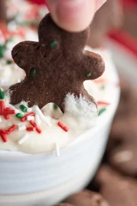 Gingerbread cookie dipped into dip.