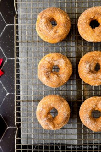 Pumpkin spice donuts on a cooling rack.