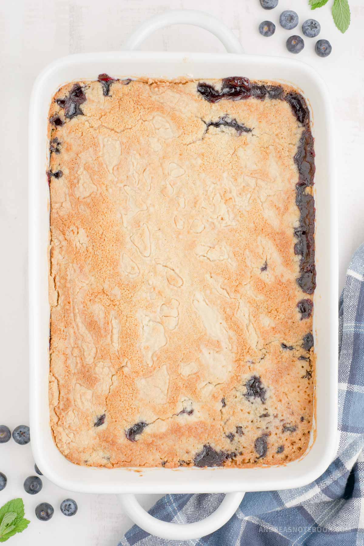 Fully baked blueberry dump cake in a baking dish.