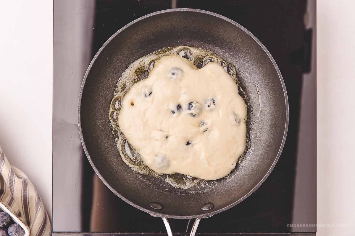 Pancake batter in a hot buttered skillet.
