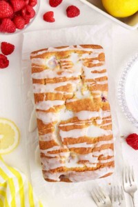 Loaf of raspberry lemon bread with glaze drizzled over top..