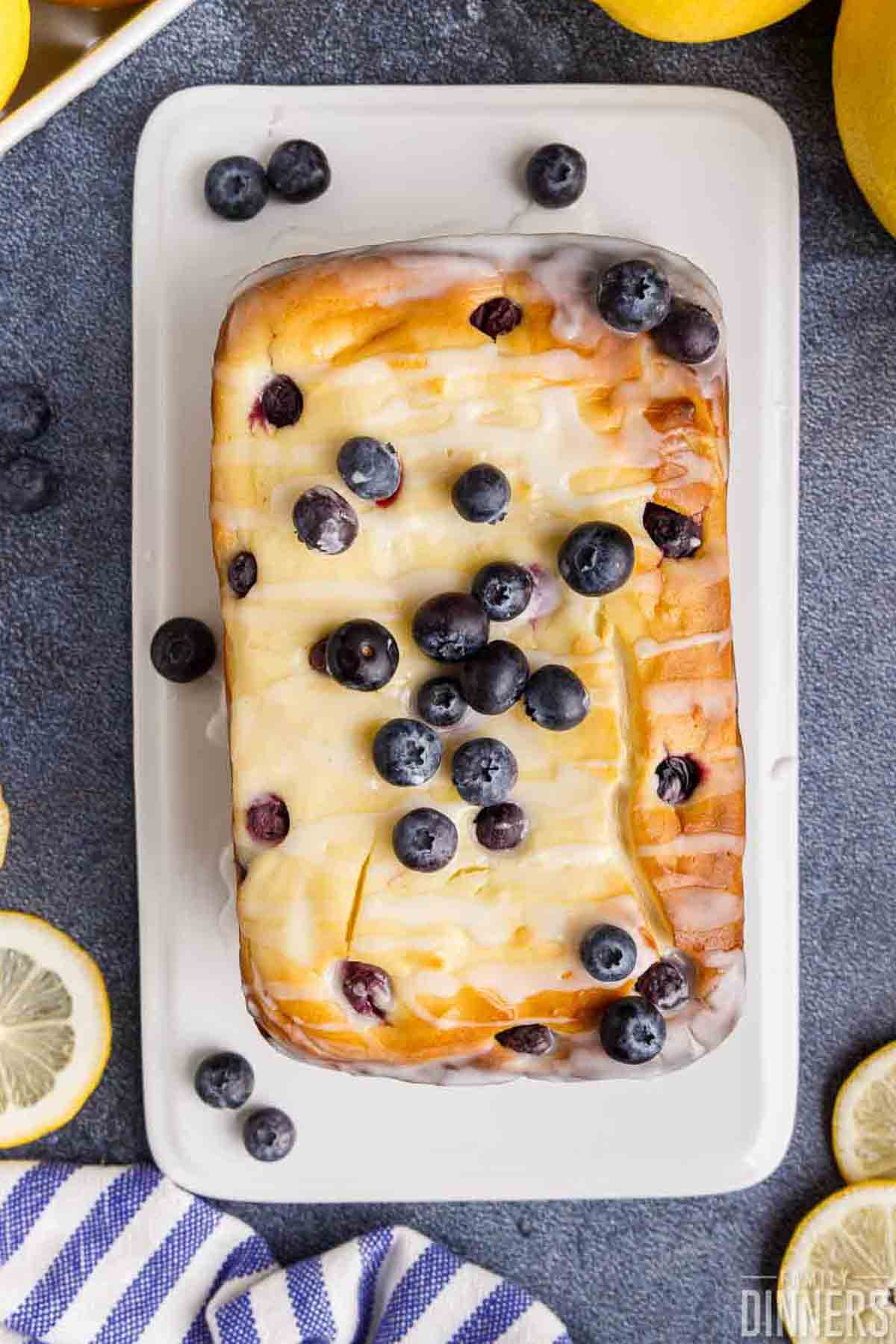 Full loaf of blueberry cream cheese lemon bread with fresh blueberries on top.