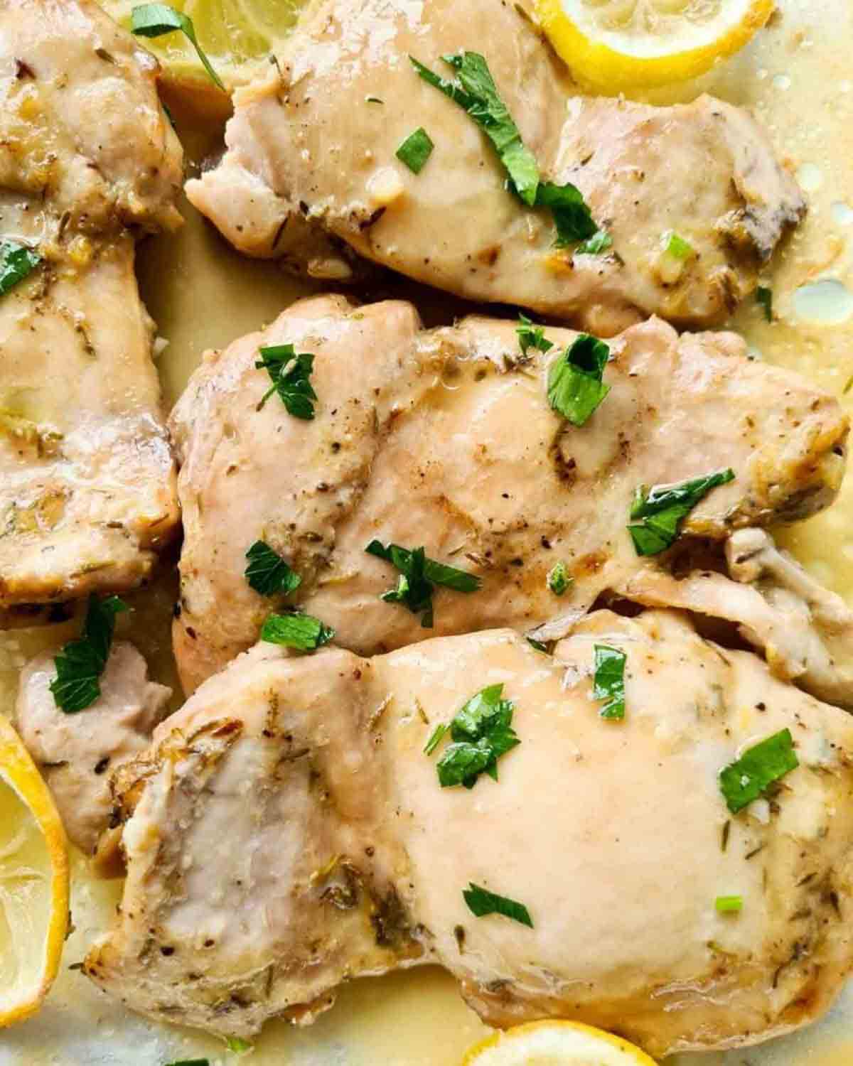 Oven baked lemon chicken thighs in a pile.
