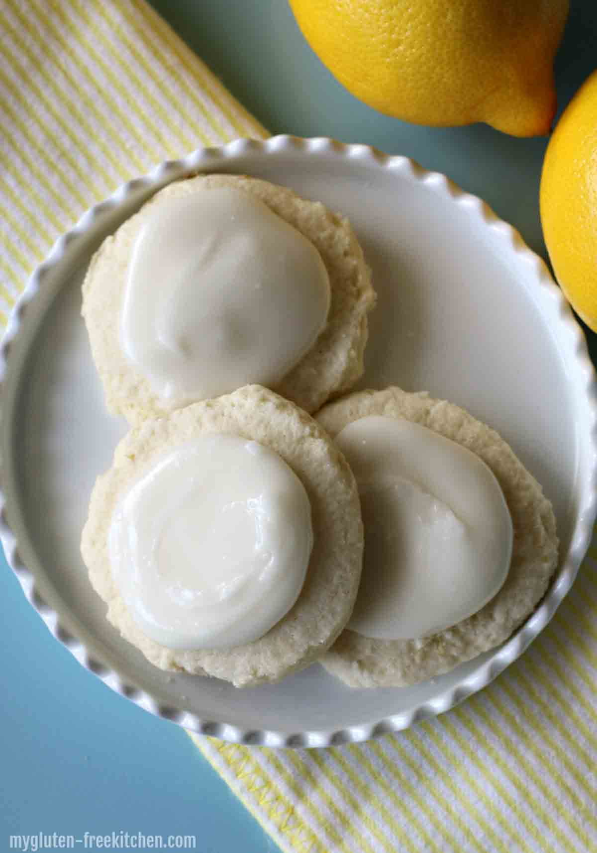Round gluten free lemon cookies with white glaze on top.