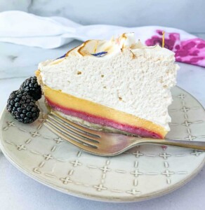 Easy blackberry lemon meringue pie recipe slice on a plate with a fork.