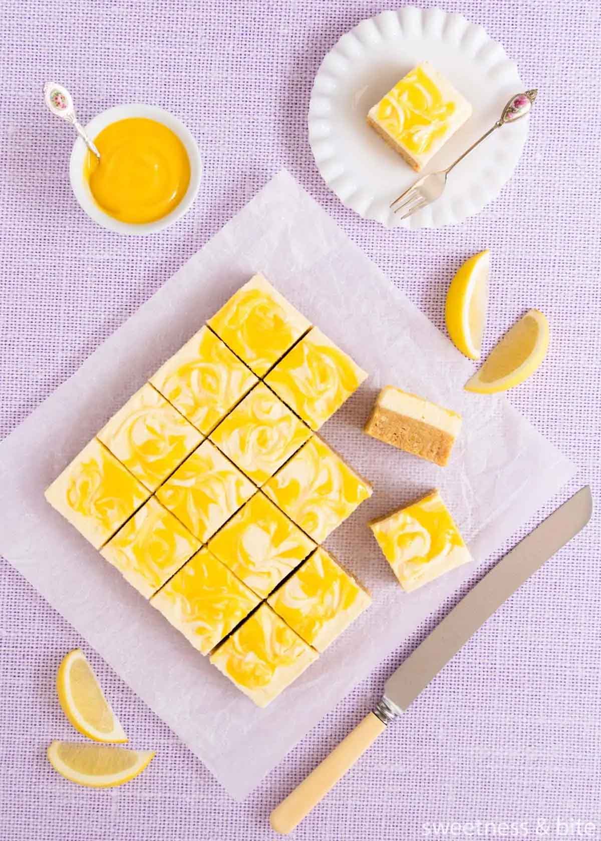 Gluten free lemon slice bars cut into squares on parchment paper.