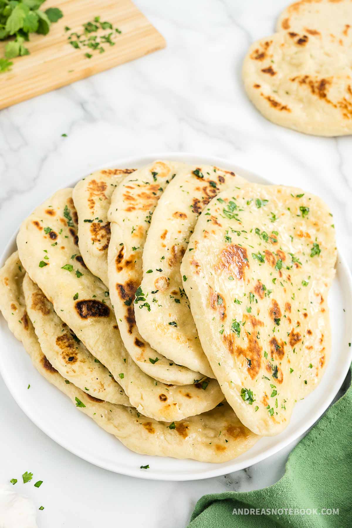 Stack of naan on a plate.