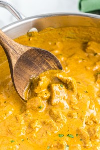 Close up of butter chicken in a skillet.