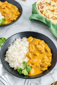 Butter chicken and rice in a bowl.