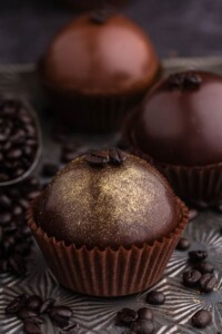 Coffee flavored hot chocolate bombs with gold dust on top.