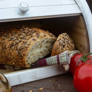 Sliced bread in a white breadbox.