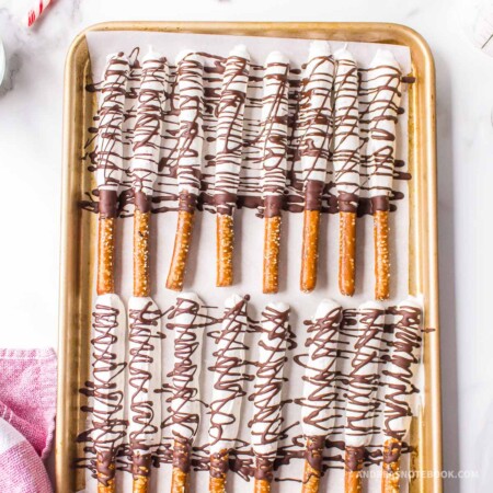 Sheet pan of mint chocolate covered pretzel rods.