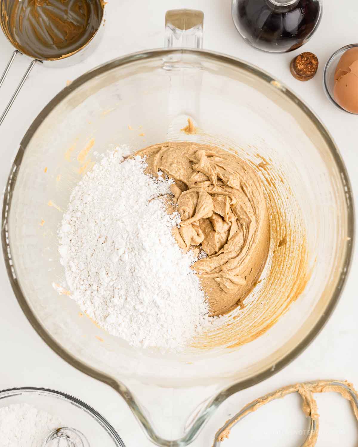 Dry ingredients poured into mixing bowl with wet ingredients.