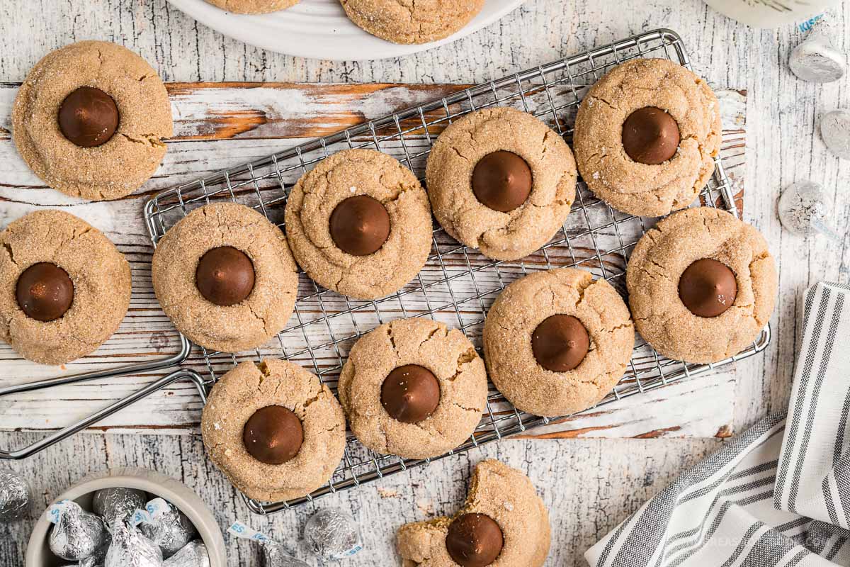 Cooling rack of peanut butter blossom hershey kiss cookies.