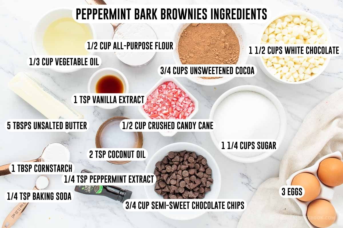 Peppermint bark brownies ingredients in small dishes including flour, sugar, cocoa powder, crushed candy cane, egg, butter, peppermint extract, etc.