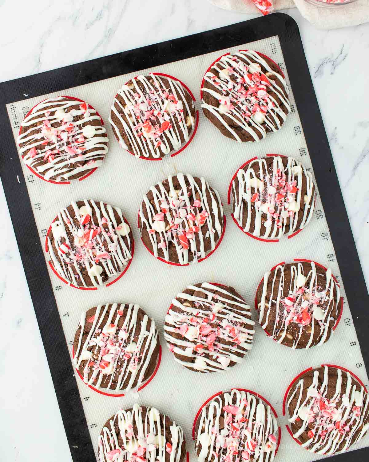 Finished cookies with white chocolate drizzle and crunched up peppermint bark.