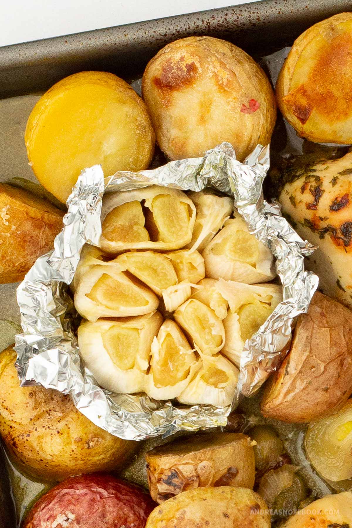 Fully roasted garlic on foil.