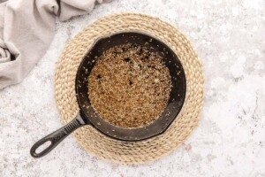 Hot pan with cumin seeds and mustard seeds.