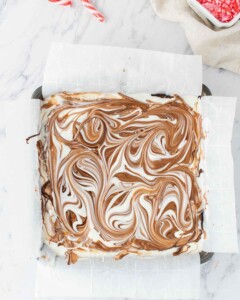White and dark chocolate swirled together on top of brownies.