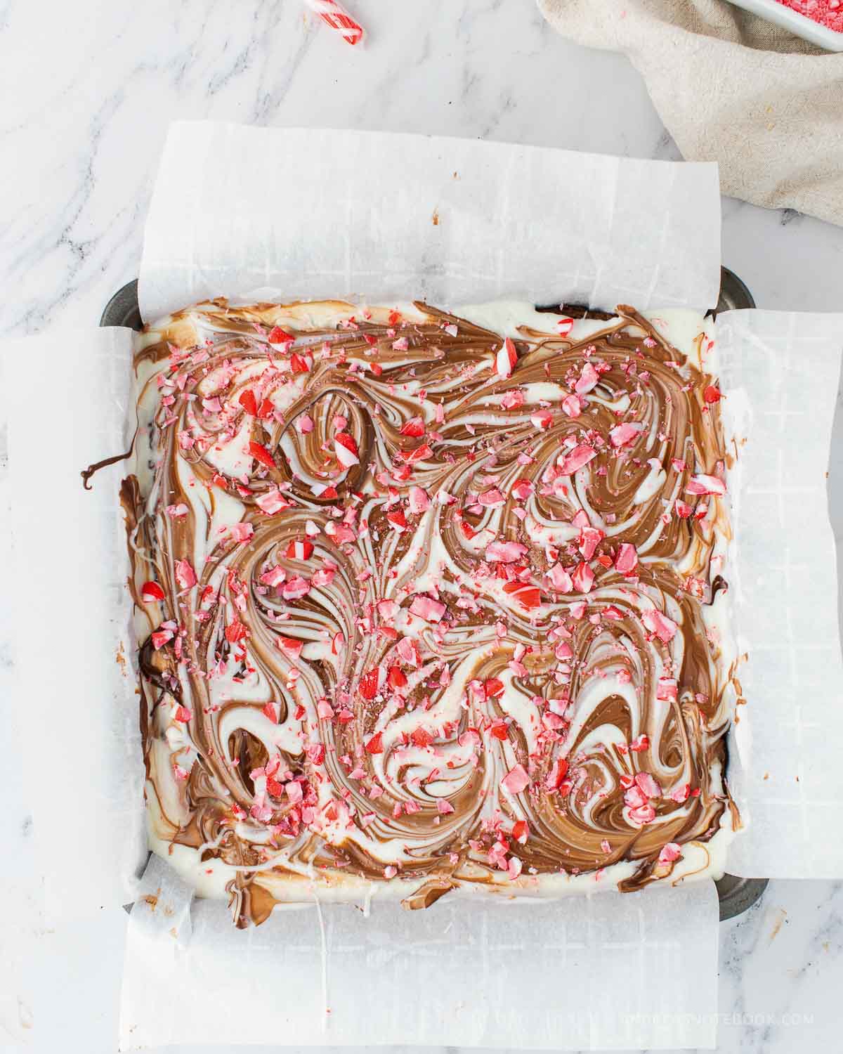 Crushed candy canes sprinkled on top of peppermint bark brownies.