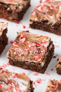 Square of chocolate peppermint bark brownie with candy cane crumbles on top.