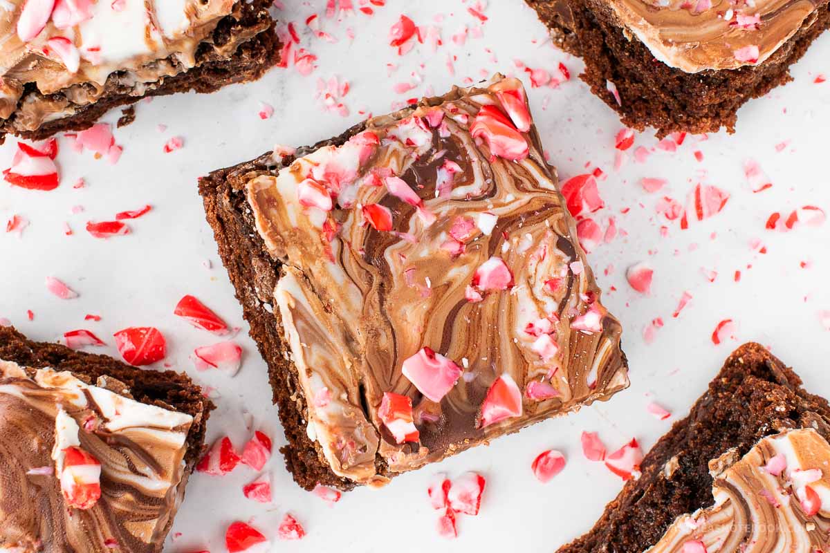 Square of chocolate peppermint bark brownie with candy cane crumbles on top.