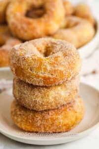 Stack of cinnamon and sugar donuts on a plate.