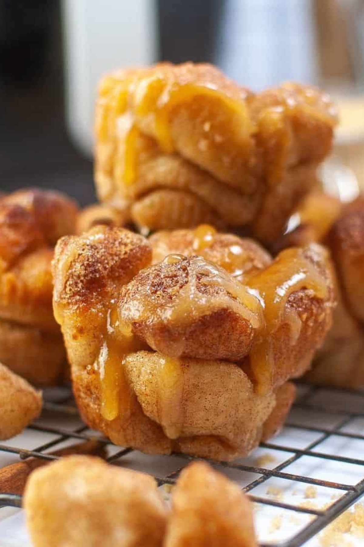 Two gooey monkey bread muffins on a cooking rack.