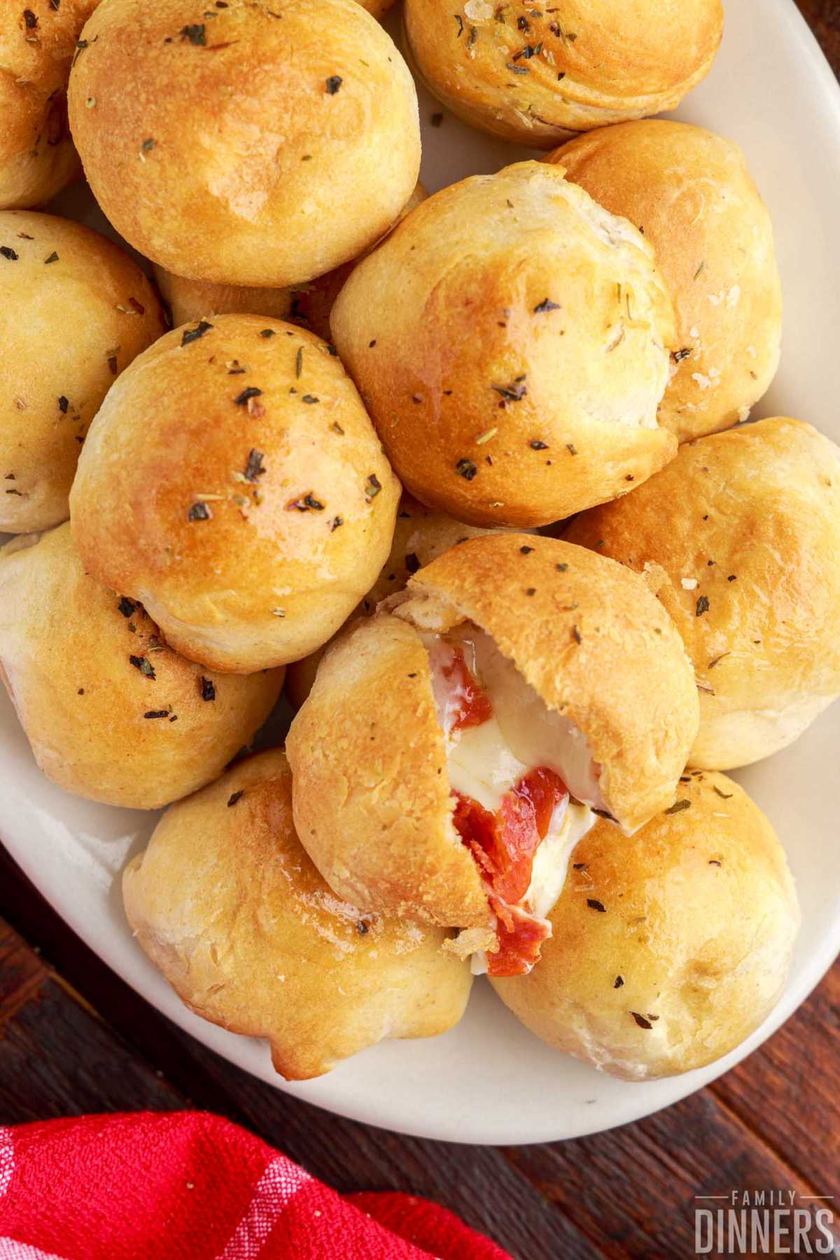 Platter full of pepperoni pizza bites made out of Pillsbury biscuit dough, mozzarella cheese and pepperoni.