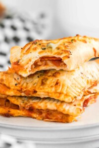 Stack of air fryer hot pockets (pizza pockets) on a plate.