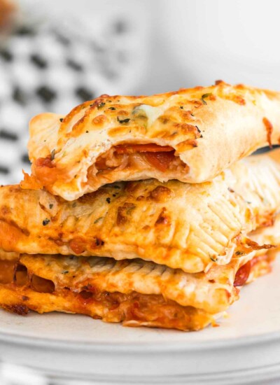Stack of air fryer hot pockets (pizza pockets) on a plate.