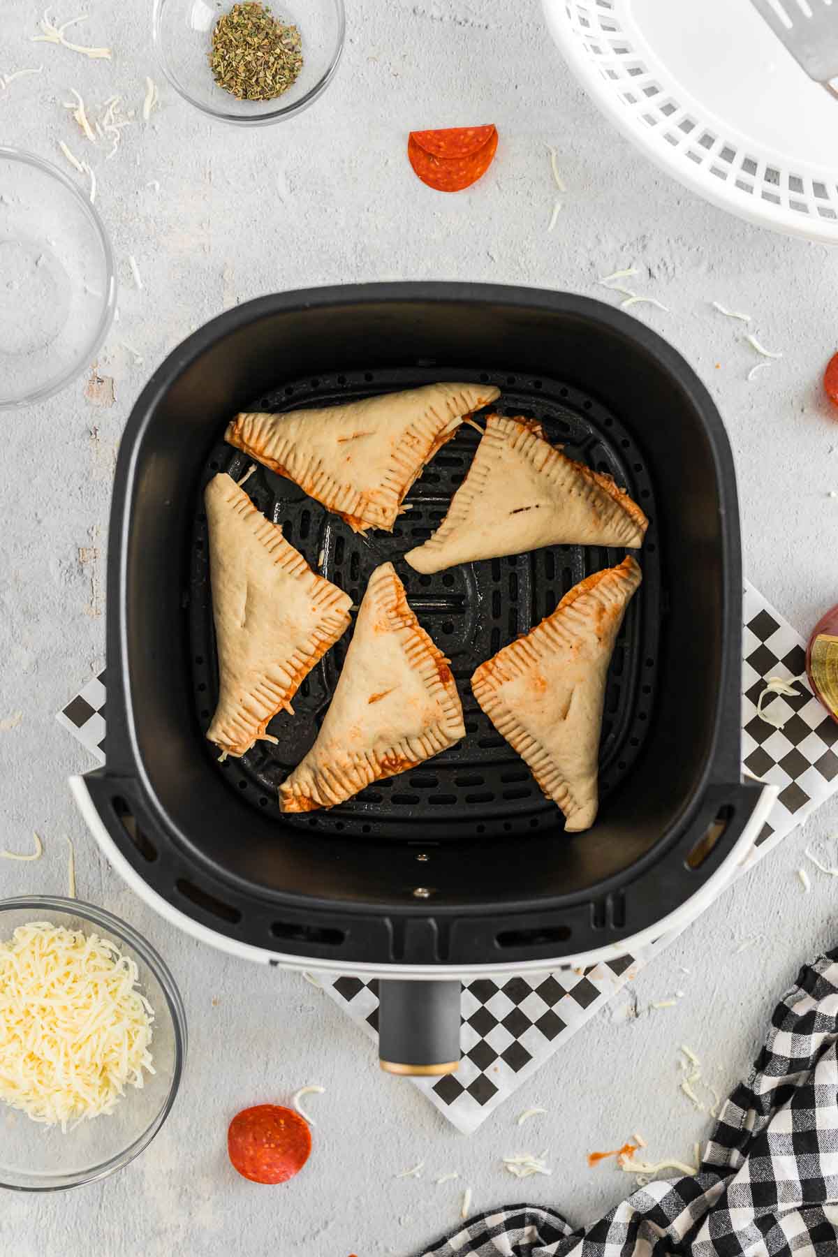 Air fryer hot pockets placed into air fryer basket.