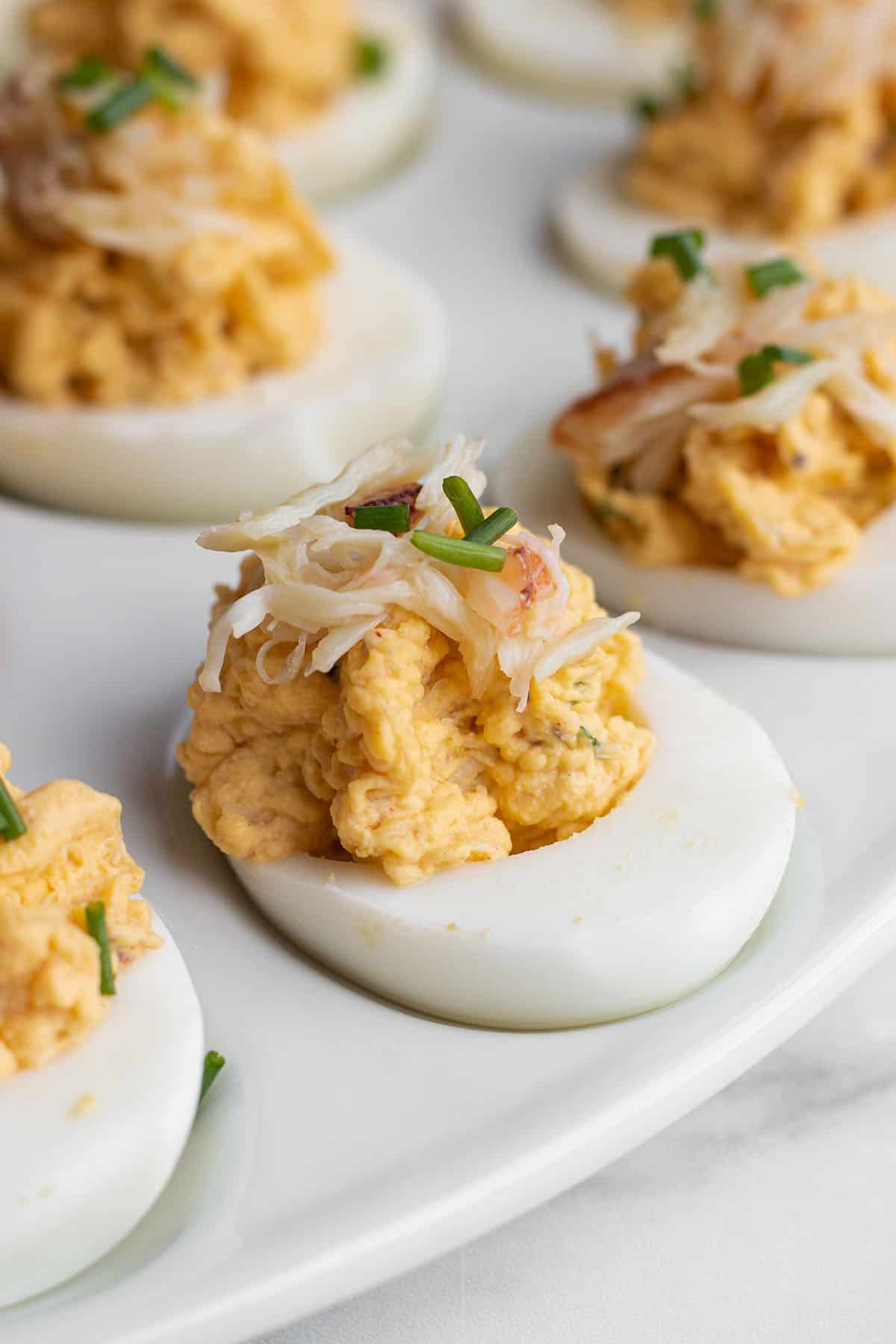 Egg plate with deviled eggs with crab on top.