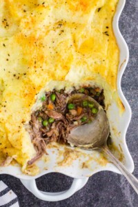 Mashed potato topped easy cottage pie - root vegetable casserole recipe with a scoop missing.