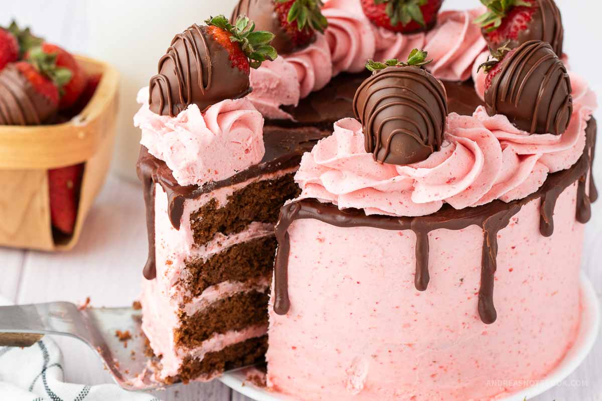 Slice of strawberry chocolate cake being removed from a layered cake.